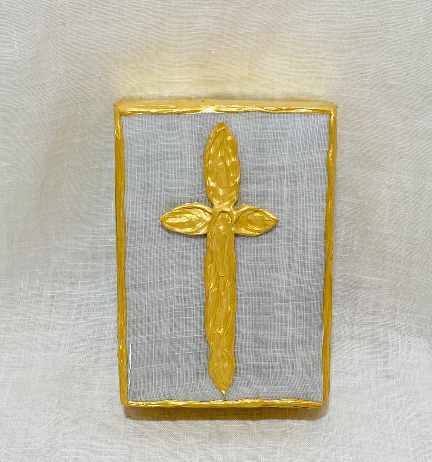 Gold Cross with Grey Tones under White Linen